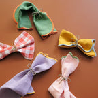 Bitossi Home Fiocco bow napkin rings in gold and silver, set of four, styled in a table setting