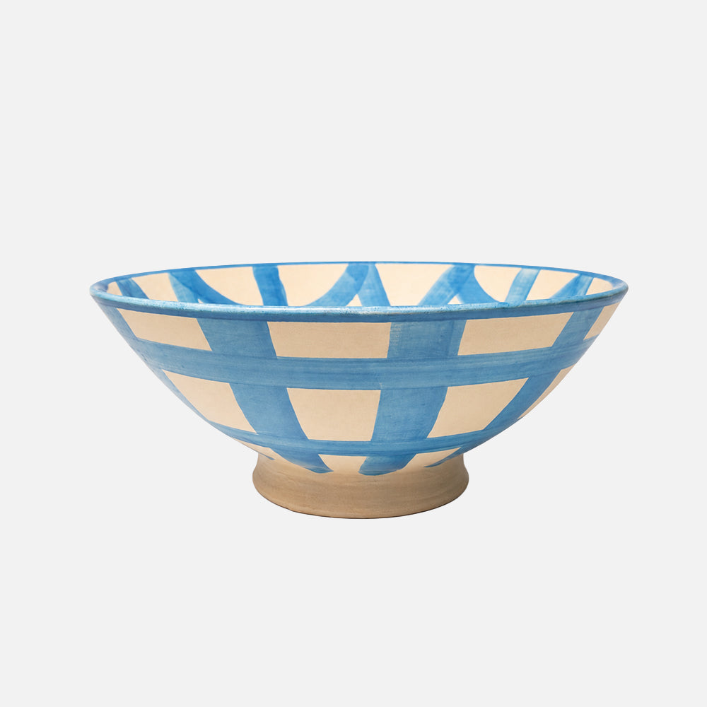 Ceramic bowl with blue and beige pattern on a white background