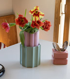 The Socialite Family Duetto vase in candy pink ceramic and almond green glass, 28cm, styled in a room setting 2