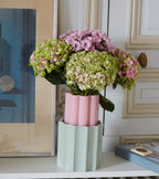 The Socialite Family Duetto vase in candy pink ceramic and almond green glass, 28cm, styled in a room setting 3