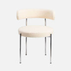 The Socialite Family Libera chair in cream curly wool with a chromed metal frame, front view