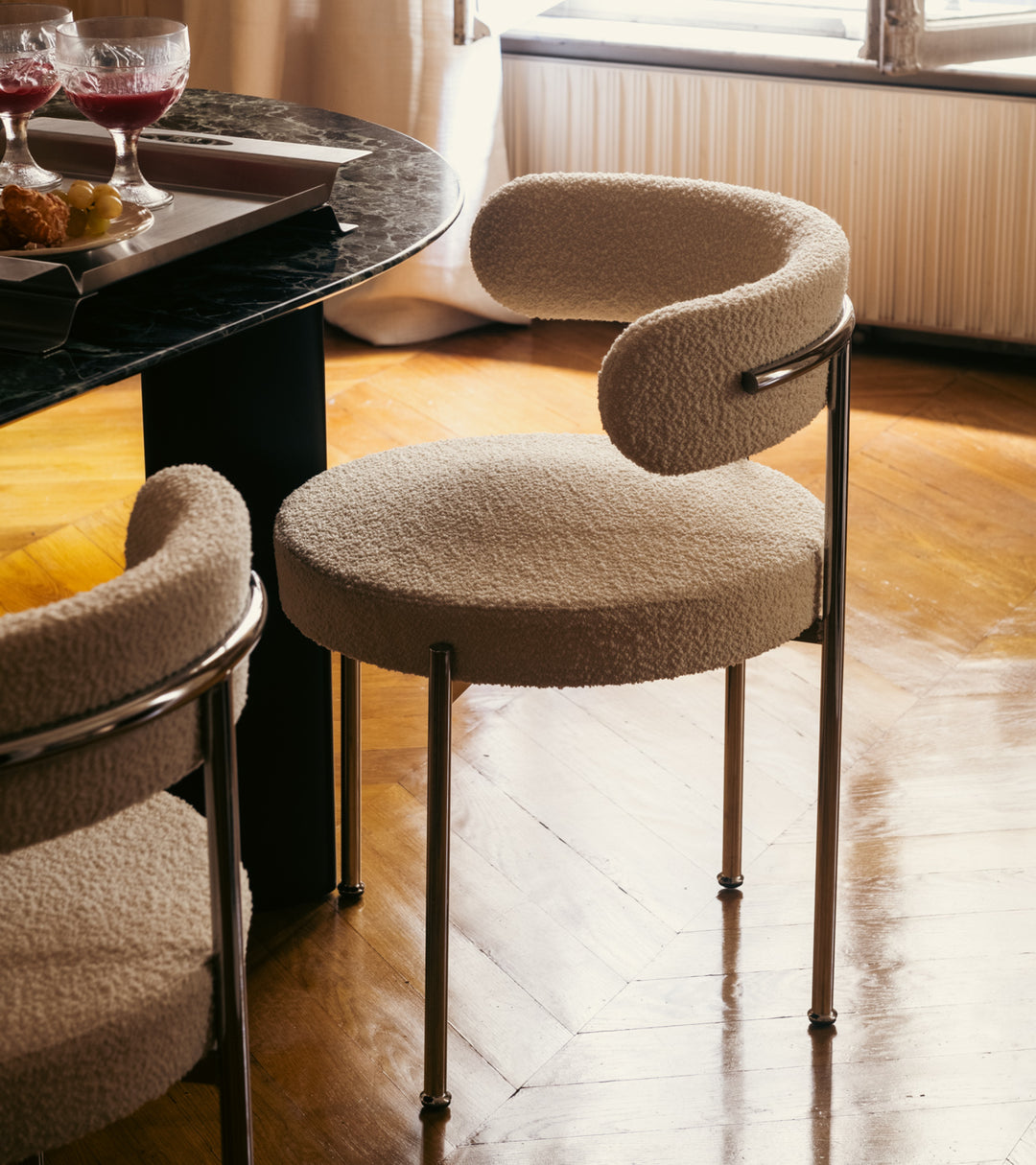 The Socialite Family Libera chair in cream curly wool with a chromed metal frame, styled in a room setting 2
