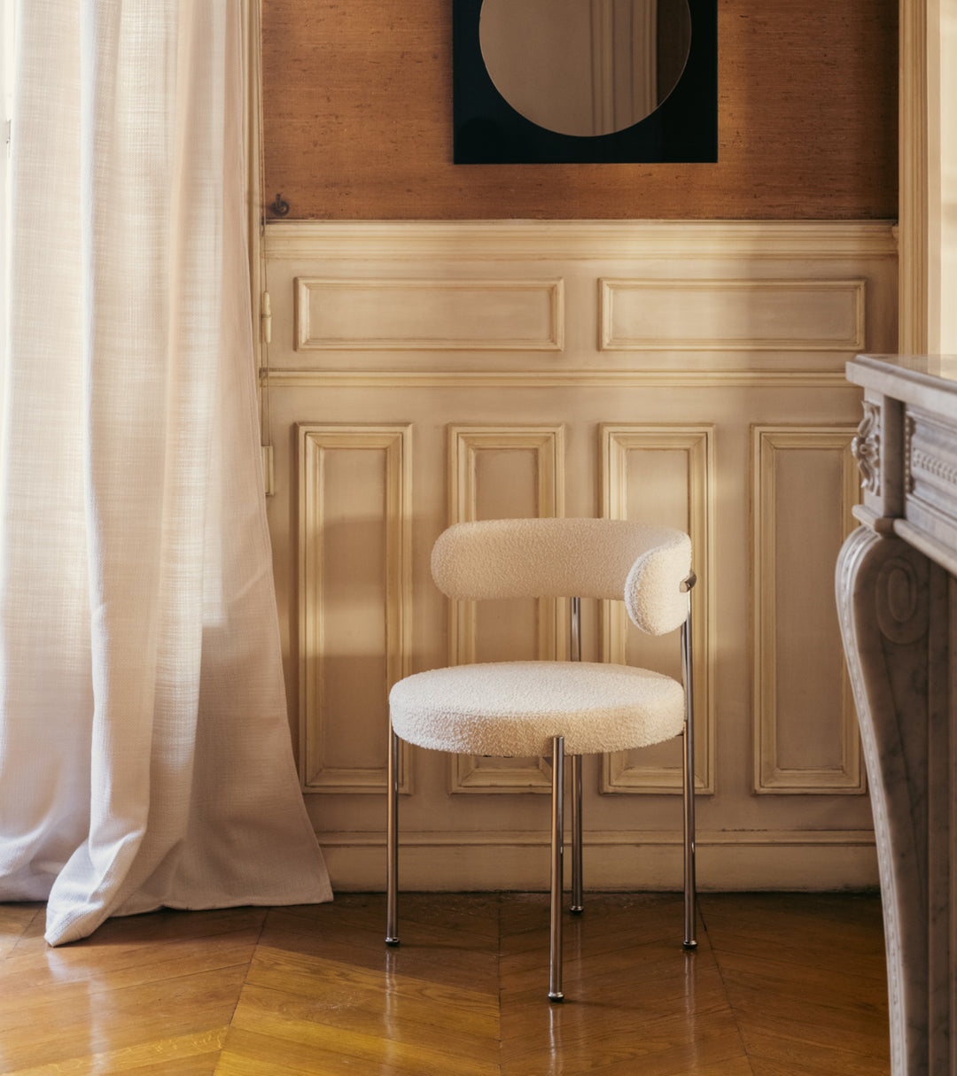 The Socialite Family Libera chair in cream curly wool with a chromed metal frame, styled in a room setting