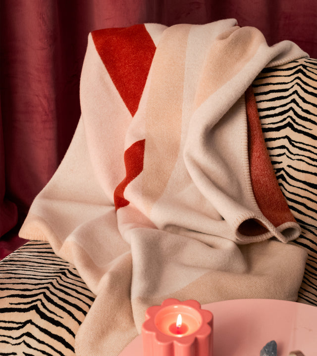 The Socialite Family Roma merino wool throw in beige and pink, 150x200cm, styled in a room setting 2
